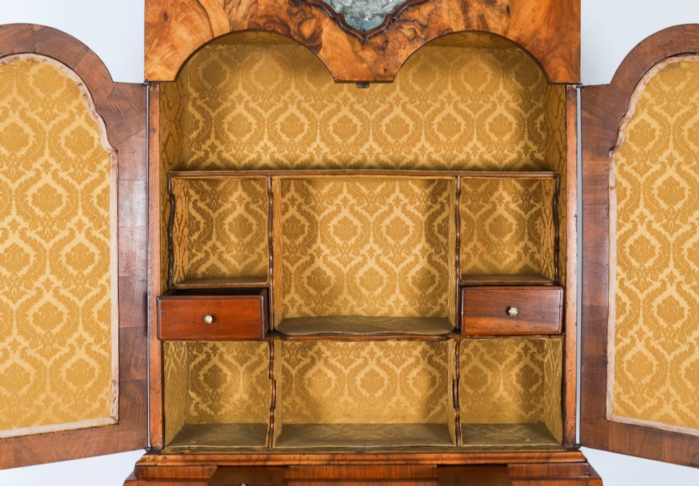 An 18th-century Venetian burr walnut bureau bookcase featuring a shaped top pediment with mirrored inset, twin mirrored cabinet doors, a slant-front writing slope, and three serpentine drawers. View XII