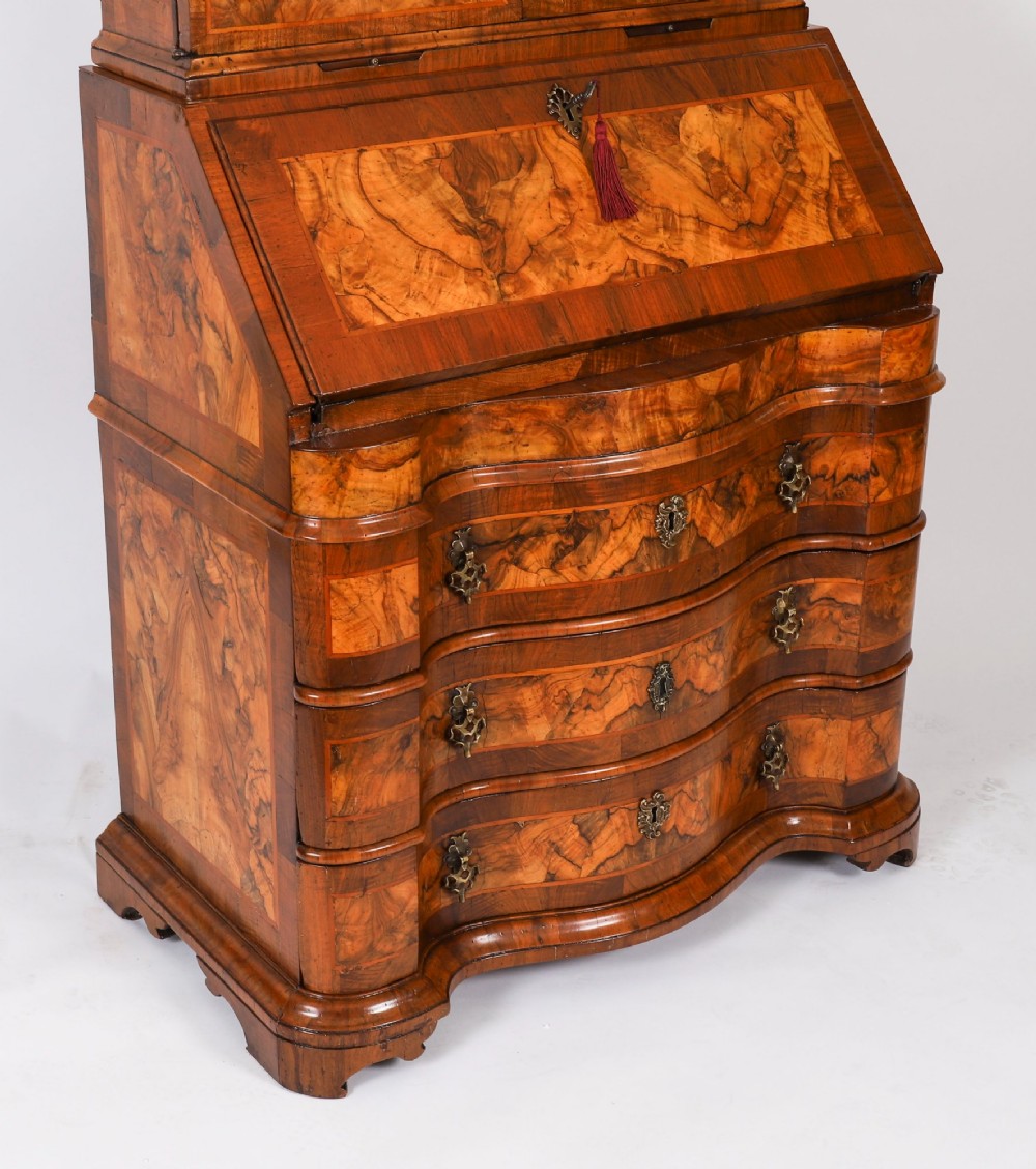 An 18th-century Venetian burr walnut bureau bookcase featuring a shaped top pediment with mirrored inset, twin mirrored cabinet doors, a slant-front writing slope, and three serpentine drawers. View XIV