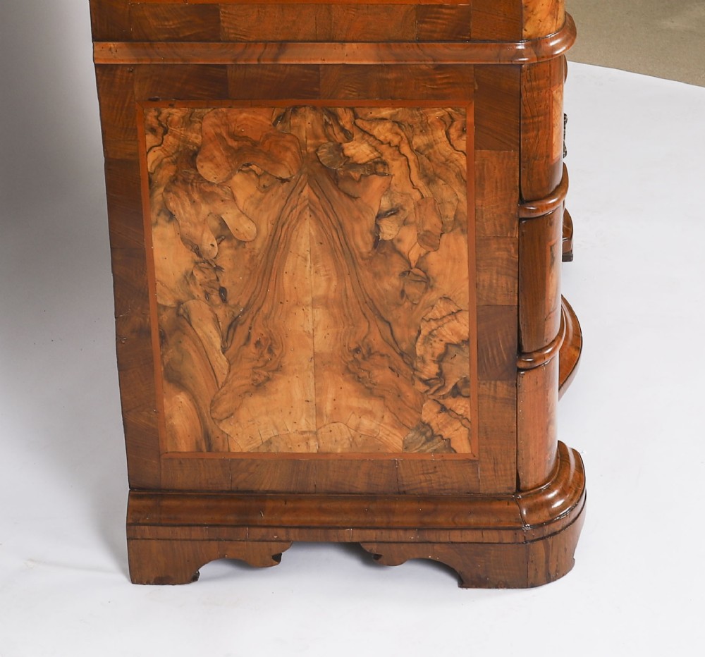 An 18th-century Venetian burr walnut bureau bookcase featuring a shaped top pediment with mirrored inset, twin mirrored cabinet doors, a slant-front writing slope, and three serpentine drawers. View XV
