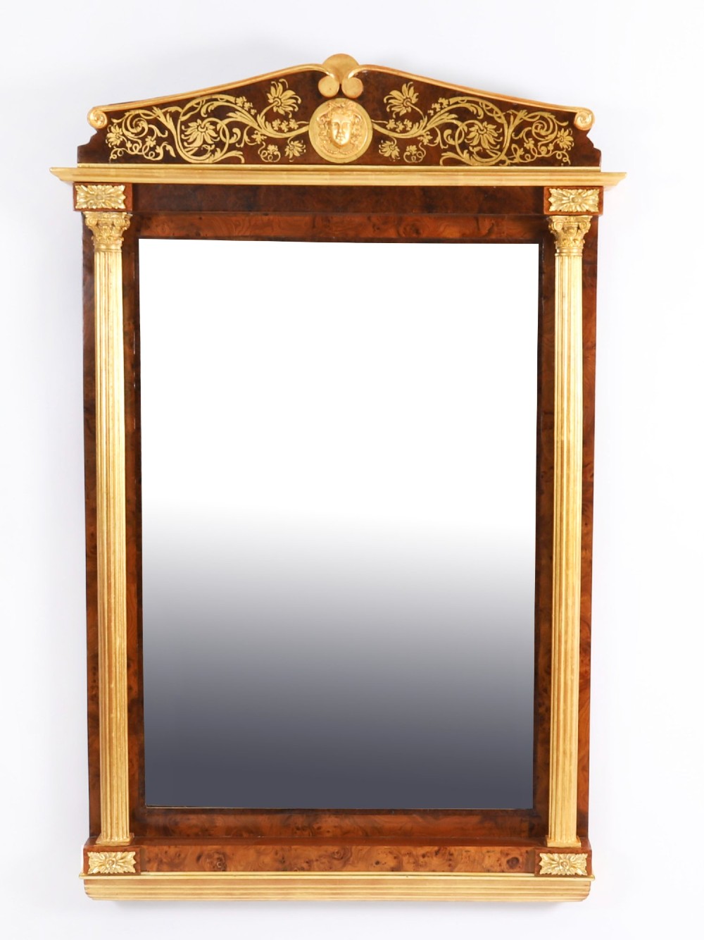 A nineteenth-century rectangular French burr walnut mirror featuring gilded fluted pilasters, classical foliate cresting with a central mask motif, and gilt rosettes. View VIII