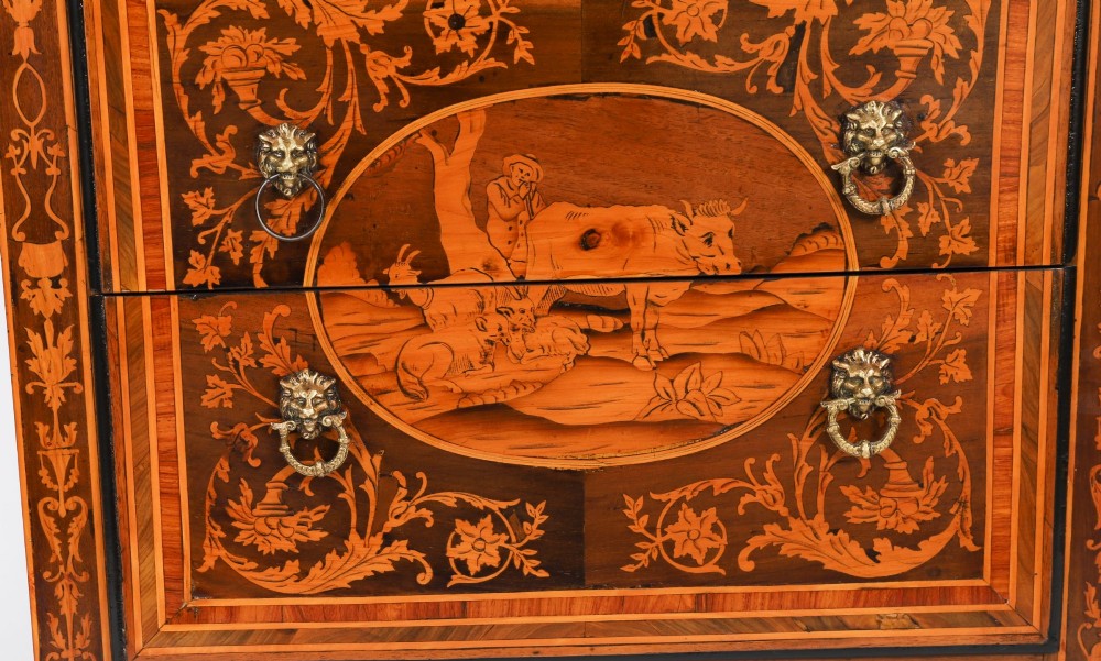 An 18th-century Italian Neoclassical walnut commodino featuring intricate foliate and pictorial marquetry inlay, three drawers with lion head ring pulls, and square tapered legs. View VI