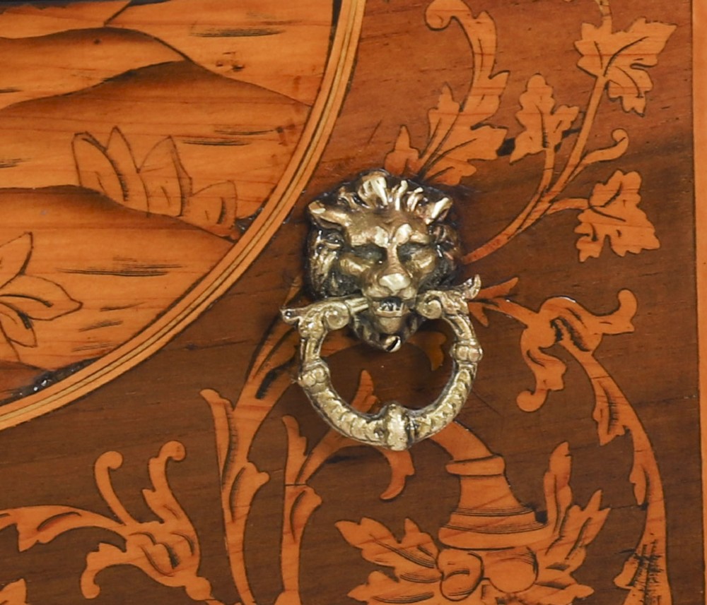 An 18th-century Italian Neoclassical walnut commodino featuring intricate foliate and pictorial marquetry inlay, three drawers with lion head ring pulls, and square tapered legs. View VII