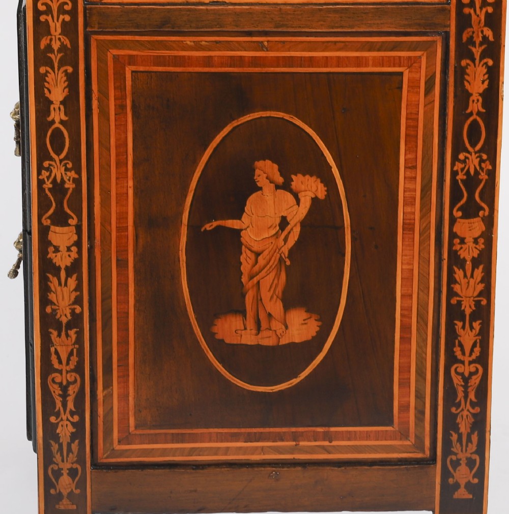 An 18th-century Italian Neoclassical walnut commodino featuring intricate foliate and pictorial marquetry inlay, three drawers with lion head ring pulls, and square tapered legs. View XII