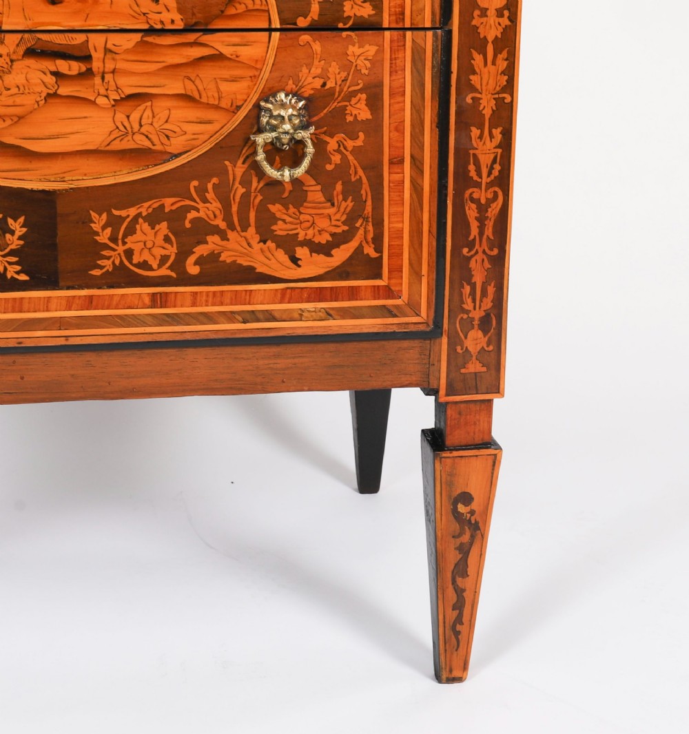 An 18th-century Italian Neoclassical walnut commodino featuring intricate foliate and pictorial marquetry inlay, three drawers with lion head ring pulls, and square tapered legs. View XIV