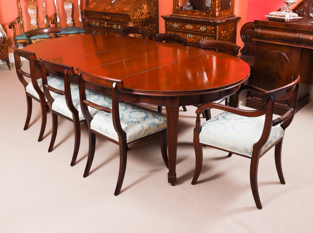 An antique Victorian oval extending dining table crafted from flame mahogany with tapered legs on brass castors. View III
