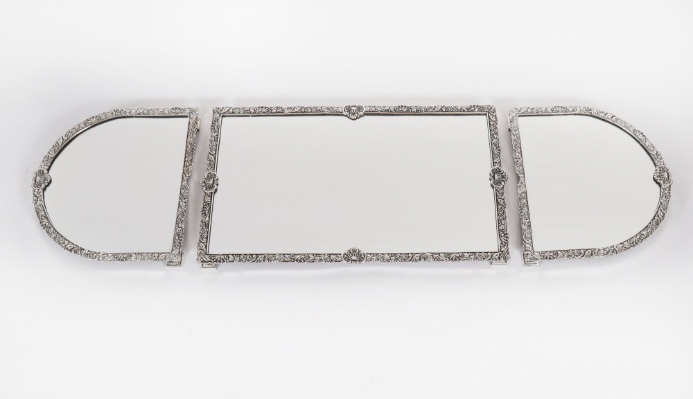 A three-piece antique French silver-plated mirrored surtout de table with ornate floral and shell border mouldings.