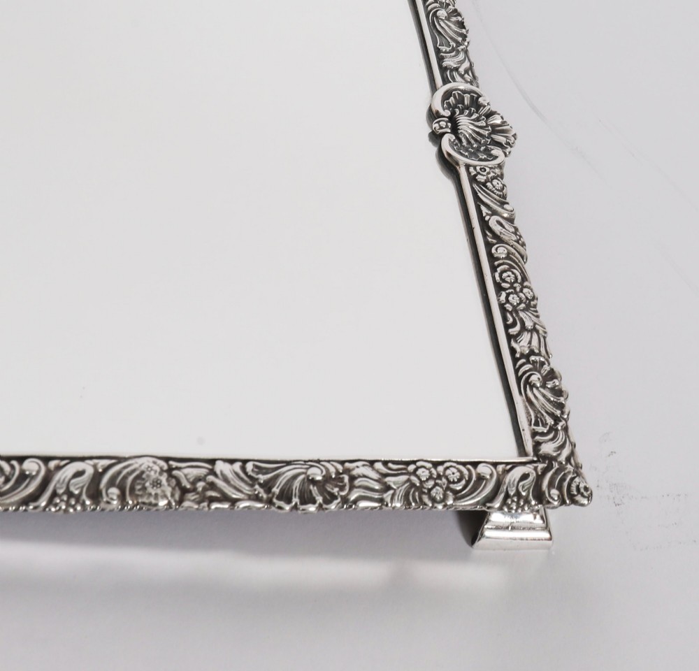 A three-piece antique French silver-plated mirrored surtout de table with ornate floral and shell border mouldings. View VI