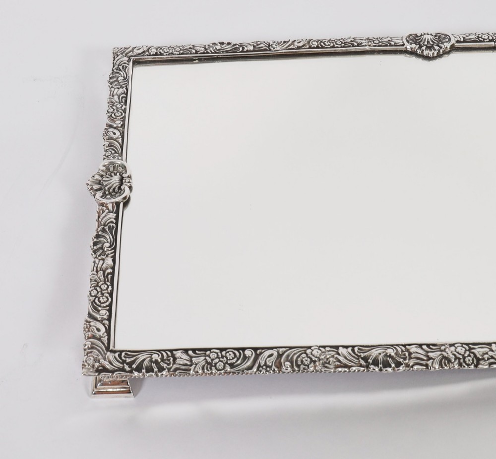 A three-piece antique French silver-plated mirrored surtout de table with ornate floral and shell border mouldings. View VII