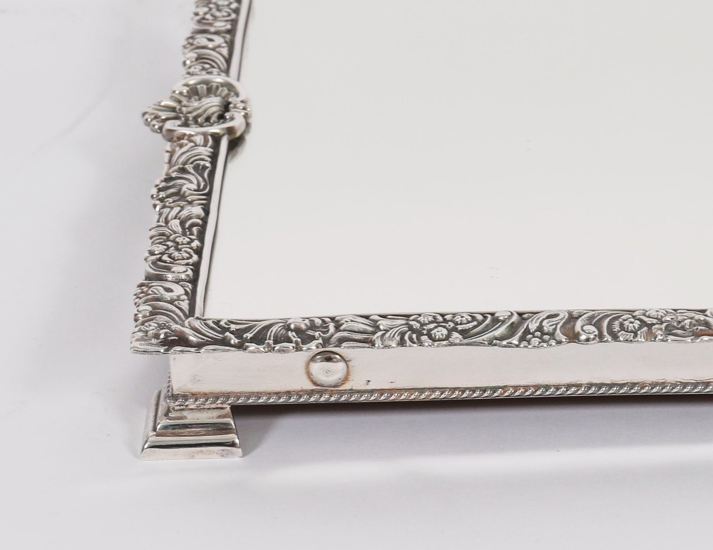 A three-piece antique French silver-plated mirrored surtout de table with ornate floral and shell border mouldings. View X