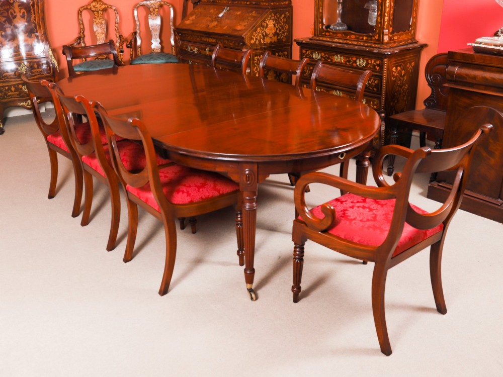 An antique Victorian flame mahogany extending dining table with fluted tapering legs set on brass castors. View II