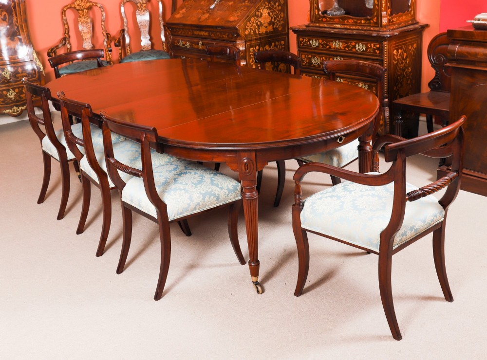 An antique Victorian flame mahogany extending dining table with fluted tapering legs set on brass castors. View III