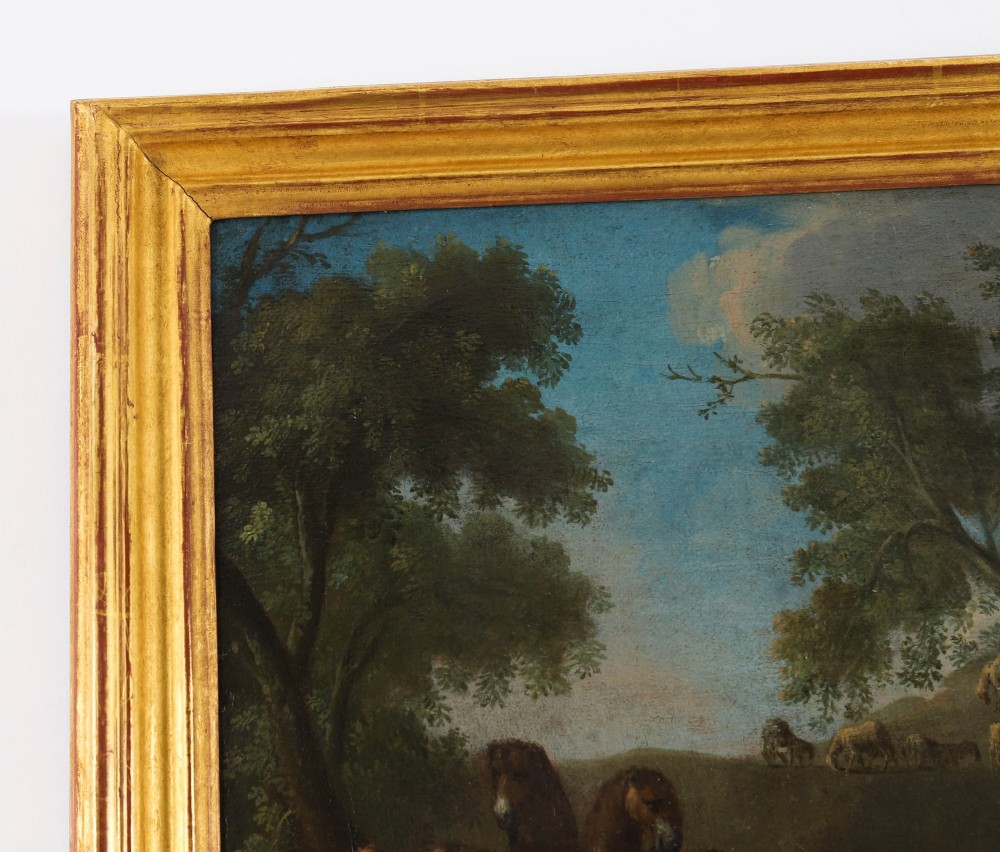 A 17th-century Italian oil painting on board depicting figures and livestock gathered at a well, set within a landscape and surrounded by a moulded gold frame. View VI