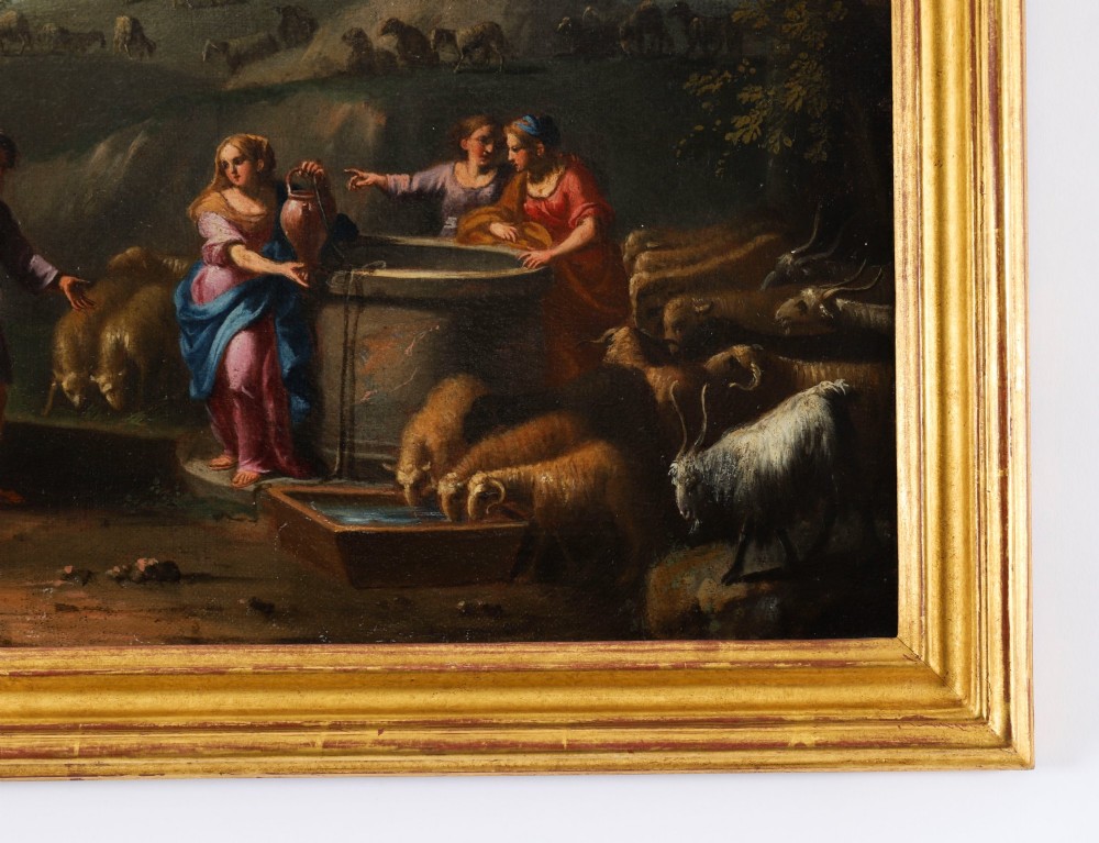 A 17th-century Italian oil painting on board depicting figures and livestock gathered at a well, set within a landscape and surrounded by a moulded gold frame. View VII