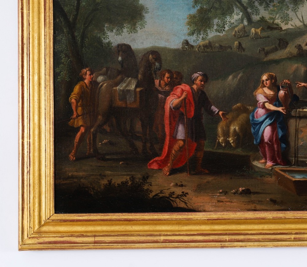 A 17th-century Italian oil painting on board depicting figures and livestock gathered at a well, set within a landscape and surrounded by a moulded gold frame. View VIII