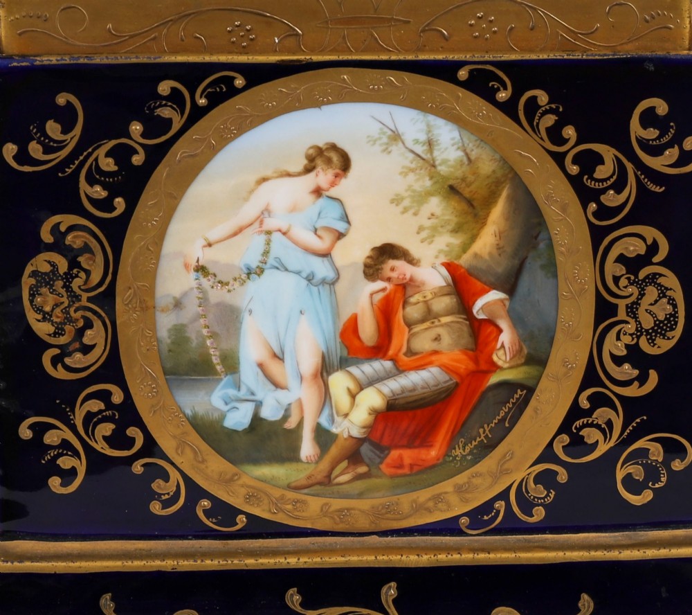 A pair of large 19th-century cobalt blue porcelain vases on matching square pedestals, featuring gilt scrollwork and hand-painted classical mythological scenes. View V