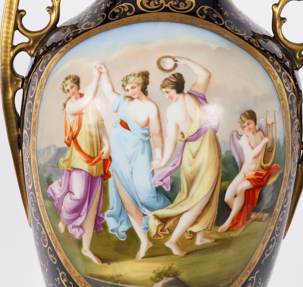 A pair of large 19th-century cobalt blue porcelain vases on matching square pedestals, featuring gilt scrollwork and hand-painted classical mythological scenes. View XI