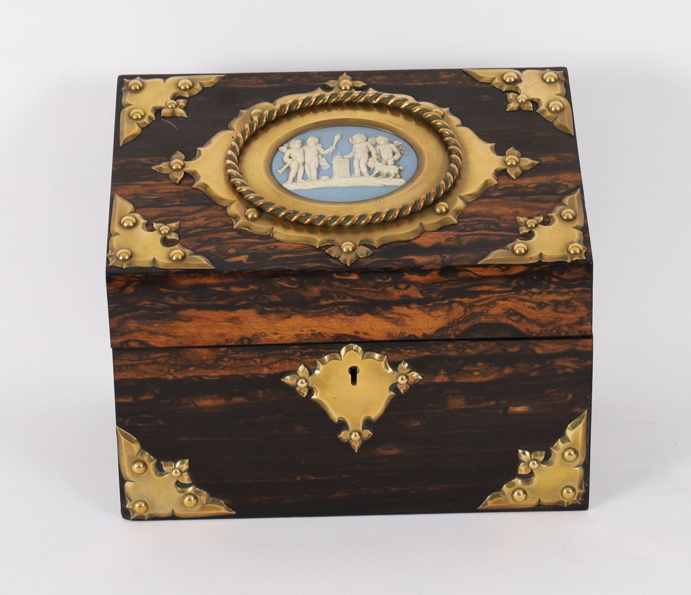 A three-piece Victorian coromandel wood desk set featuring gilt ormolu mounts, brass strapwork, and light blue oval jasperware plaques. View IV
