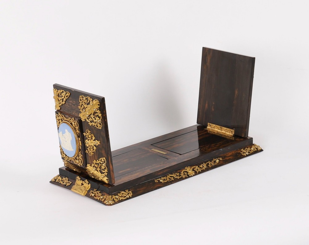 A three-piece Victorian coromandel wood desk set featuring gilt ormolu mounts, brass strapwork, and light blue oval jasperware plaques. View IX