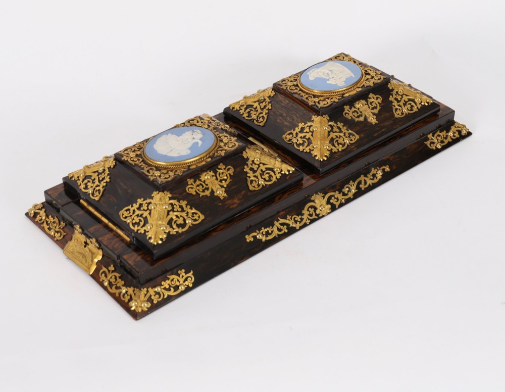A three-piece Victorian coromandel wood desk set featuring gilt ormolu mounts, brass strapwork, and light blue oval jasperware plaques. View XI