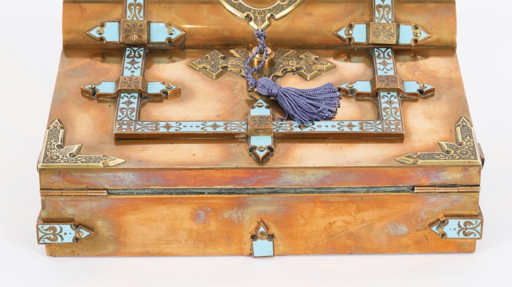 A Victorian gilt brass and turquoise champleve enamel writing slope featuring a domed upper compartment, a sloped front lid, and a key with a purple tassel in the lock. View IV