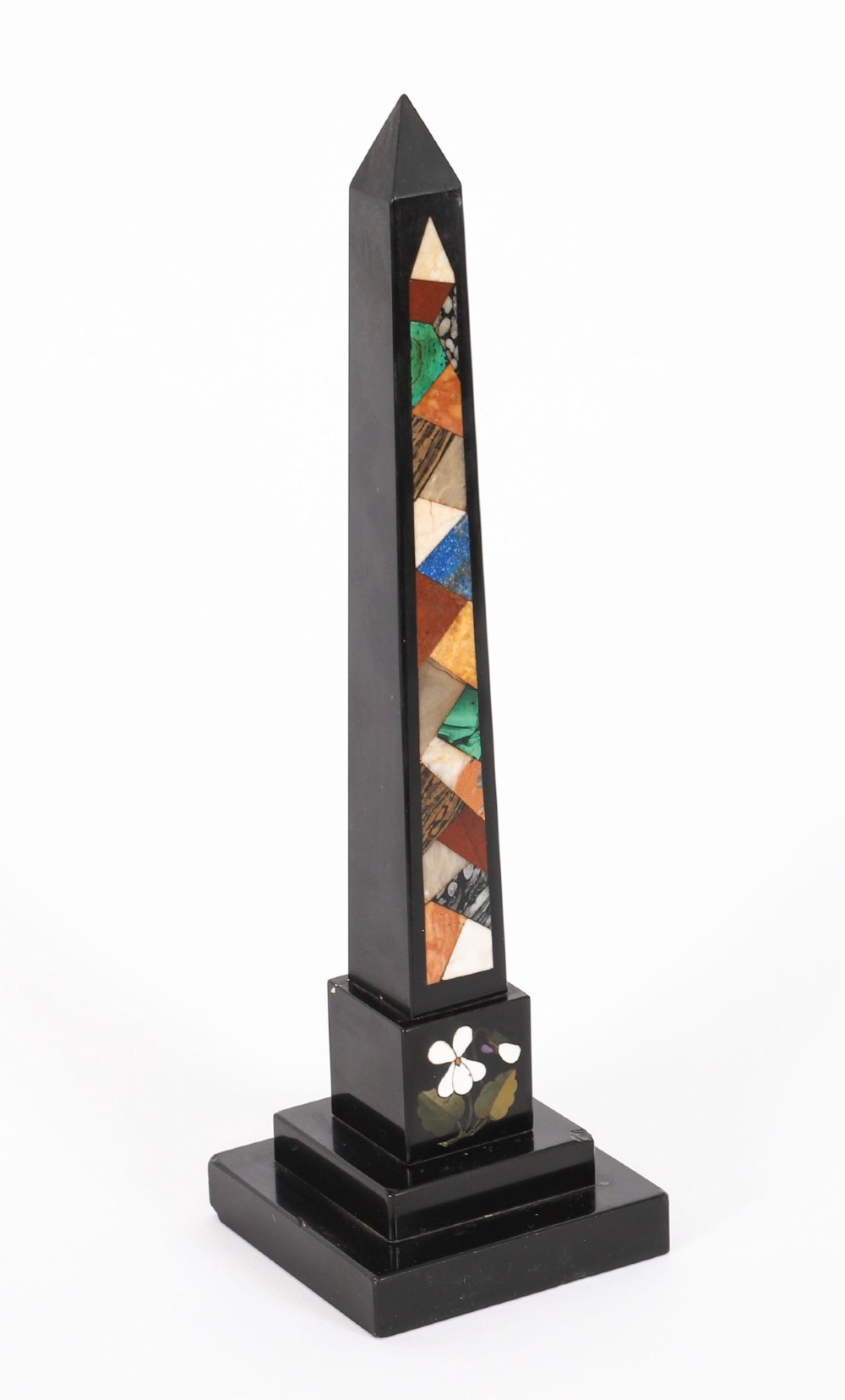 A pair of antique black marble obelisks featuring colourful geometric stone inlays along the shaft and floral inlaid detail on stepped square bases. View IV