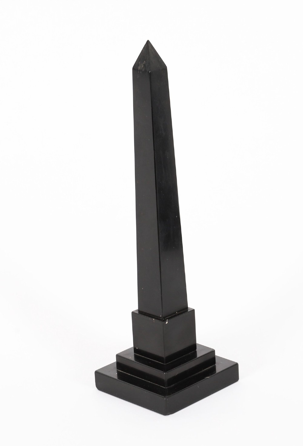 A pair of antique black marble obelisks featuring colourful geometric stone inlays along the shaft and floral inlaid detail on stepped square bases. View VII