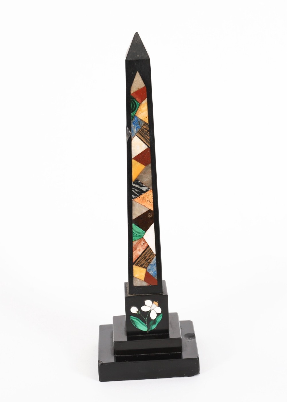A pair of antique black marble obelisks featuring colourful geometric stone inlays along the shaft and floral inlaid detail on stepped square bases. View XII