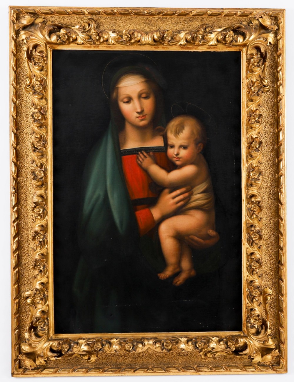An early 19th-century oil painting depicting the Virgin Mary holding the infant Christ, framed in an ornate carved gold leaf frame.