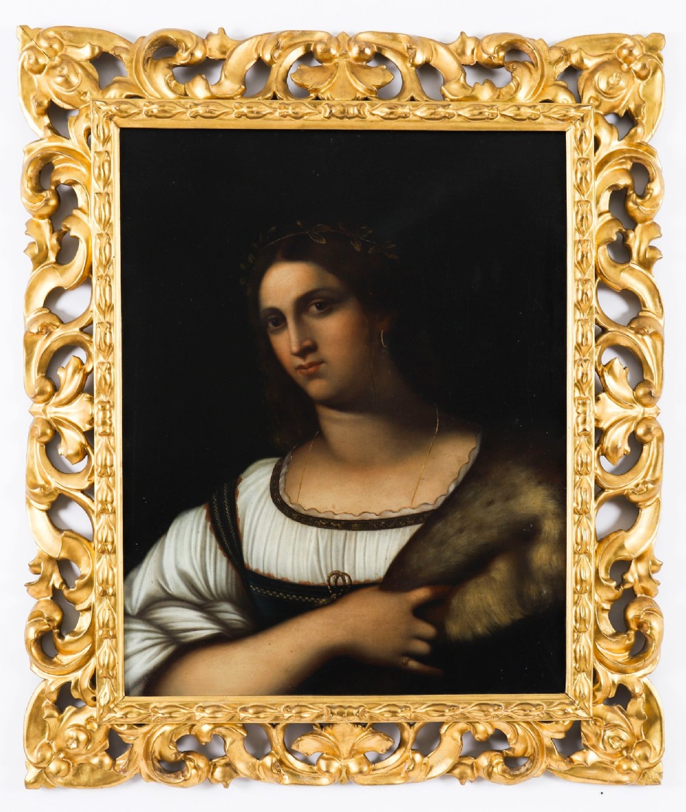 An early 19th-century portrait oil painting of a woman in classical attire set within a heavily carved gold giltwood frame.