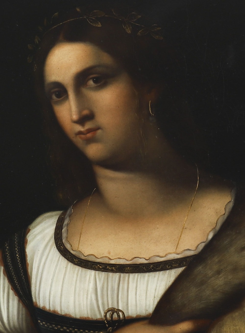 An early 19th-century portrait oil painting of a woman in classical attire set within a heavily carved gold giltwood frame. View IV
