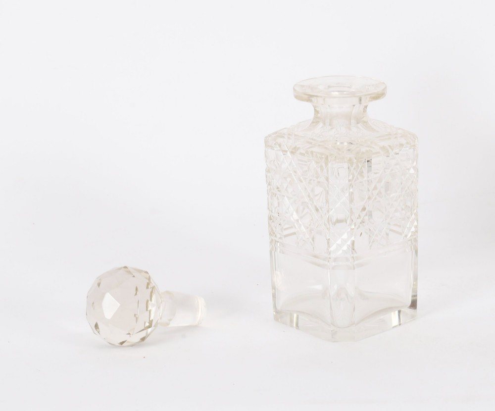 A 19th-century Victorian figured oak three-bottle tantalus open to reveal three cut glass decanters, a fitted cribbage board, and a drop-front drawer containing a silver-plated tray and playing cards. View XV