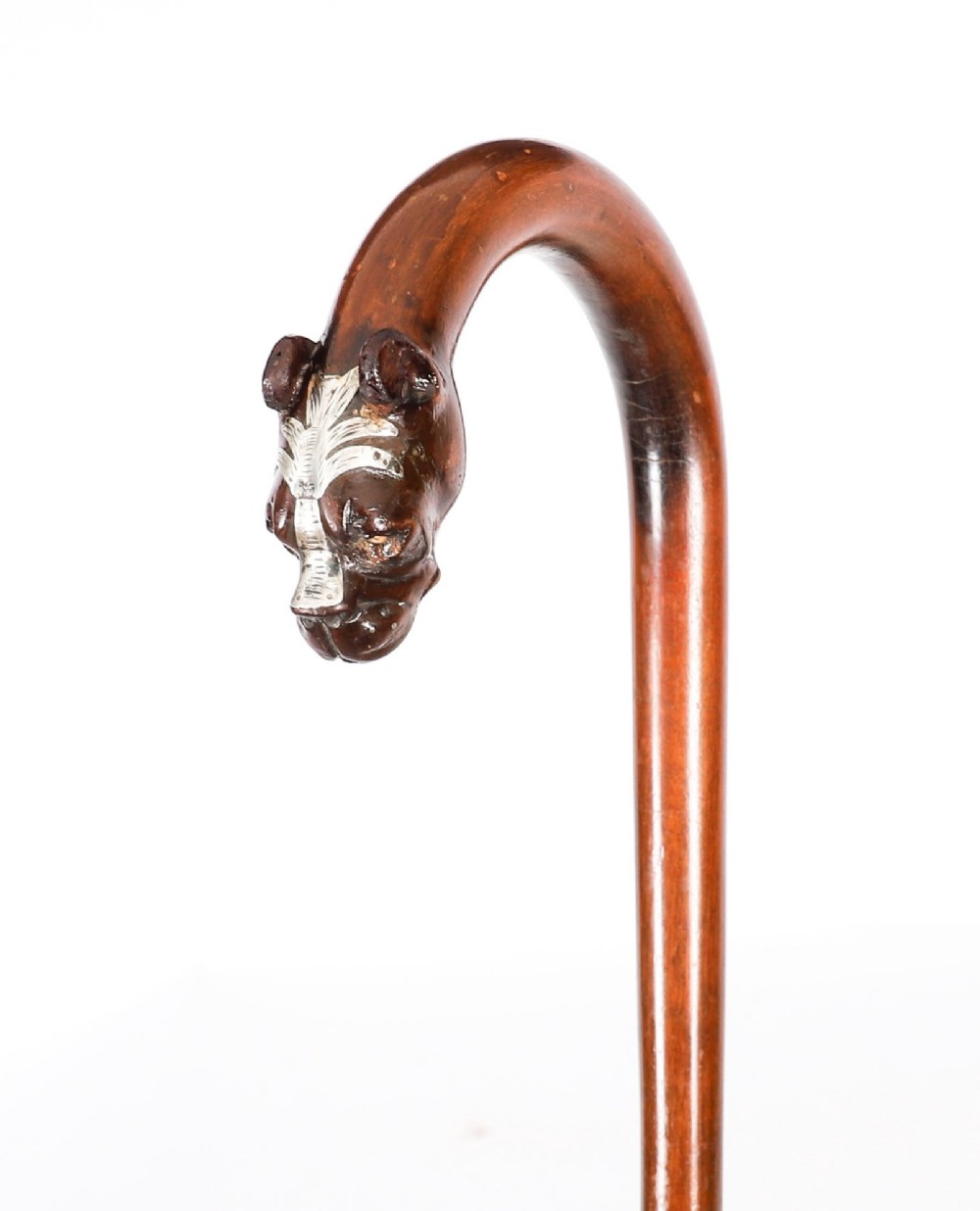 An antique dark wood walking stick featuring a curved crook handle carved into the detailed head of a boxer dog. View II