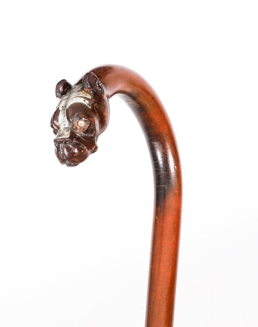 An antique dark wood walking stick featuring a curved crook handle carved into the detailed head of a boxer dog. View X