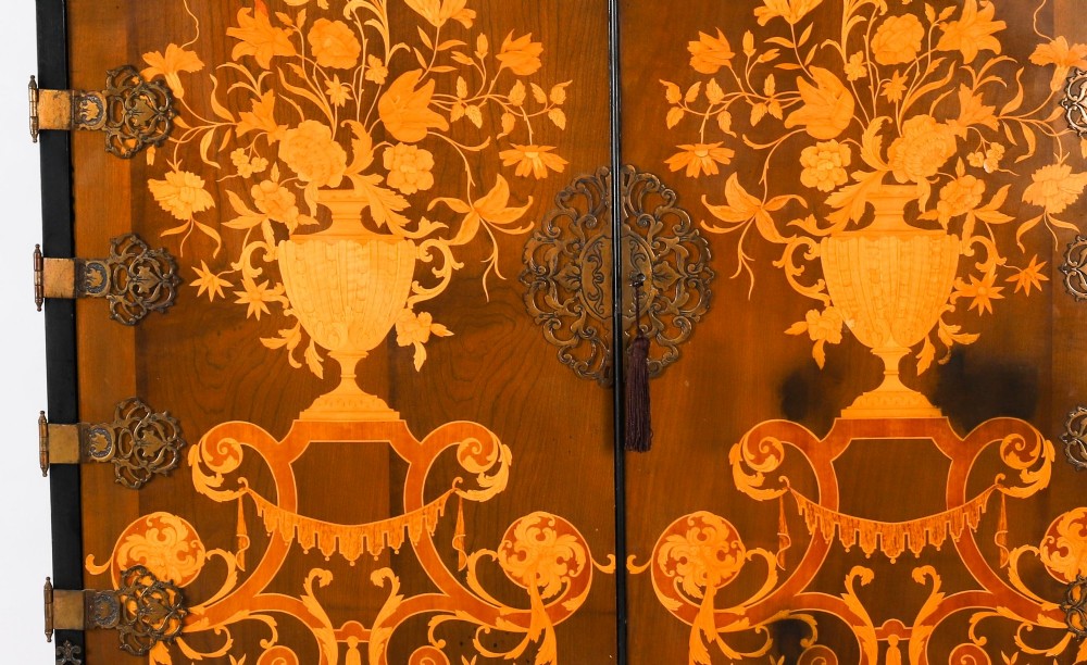 A black lacquered and inlaid wooden cocktail cabinet featuring ornate floral marquetry and decorative brass straps, resting on a carved gilded stand with cabriole legs. View VI