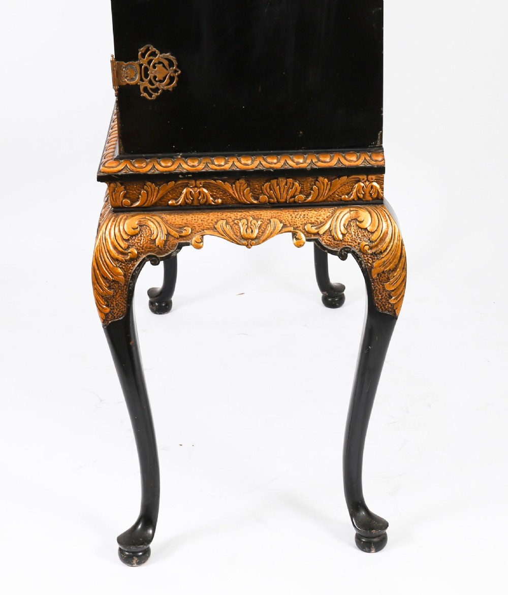 A black lacquered and inlaid wooden cocktail cabinet featuring ornate floral marquetry and decorative brass straps, resting on a carved gilded stand with cabriole legs. View XIV
