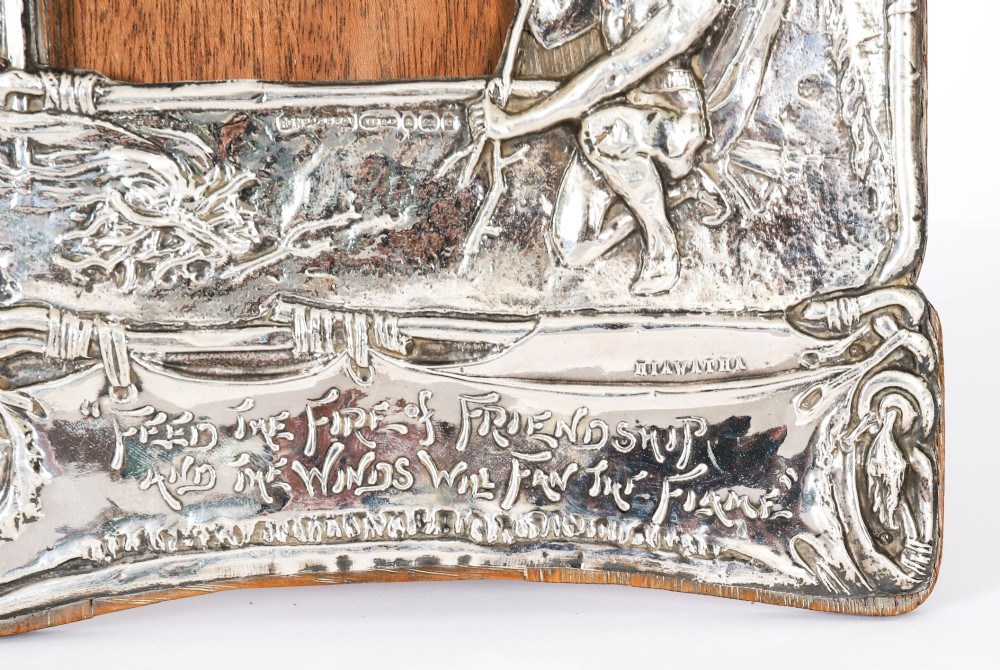 An Edwardian sterling silver picture frame featuring an embossed relief scene of Hiawatha with a wooden backing. View III