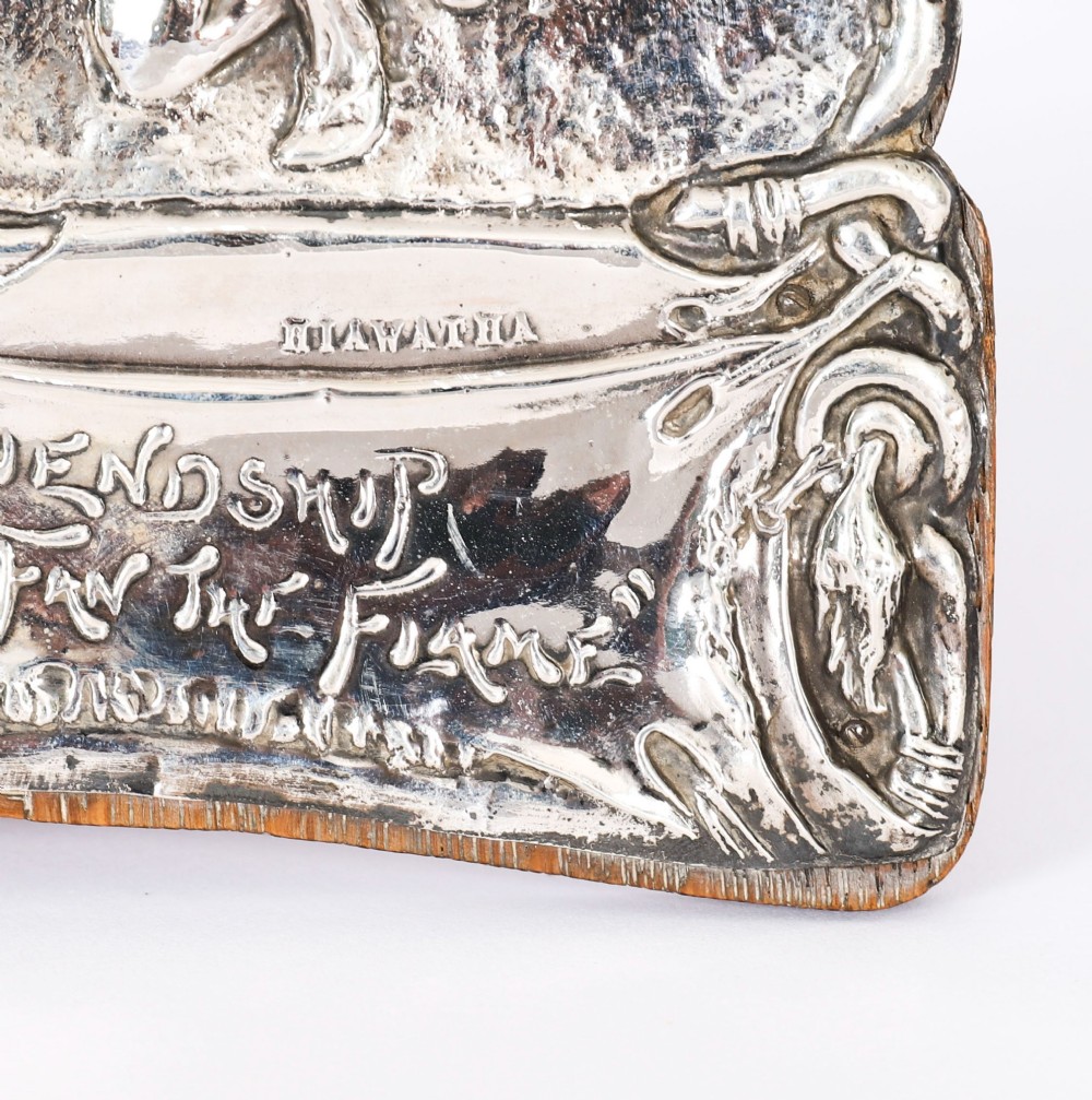 An Edwardian sterling silver picture frame featuring an embossed relief scene of Hiawatha with a wooden backing. View IV