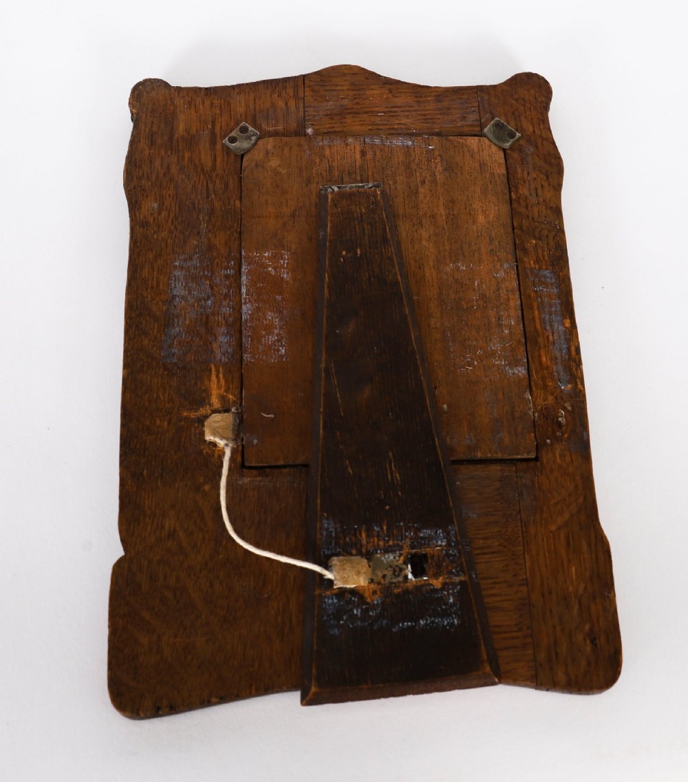 An Edwardian sterling silver picture frame featuring an embossed relief scene of Hiawatha with a wooden backing. View XI