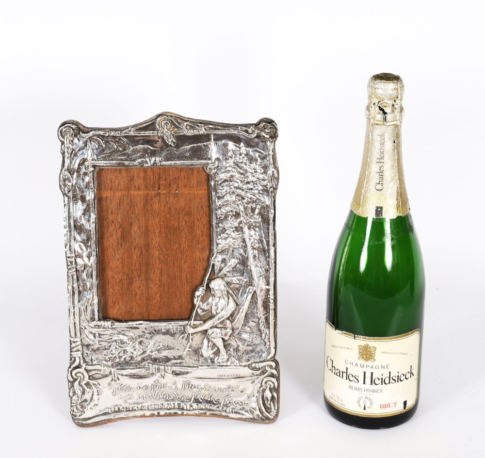 An Edwardian sterling silver picture frame featuring an embossed relief scene of Hiawatha with a wooden backing. View XII
