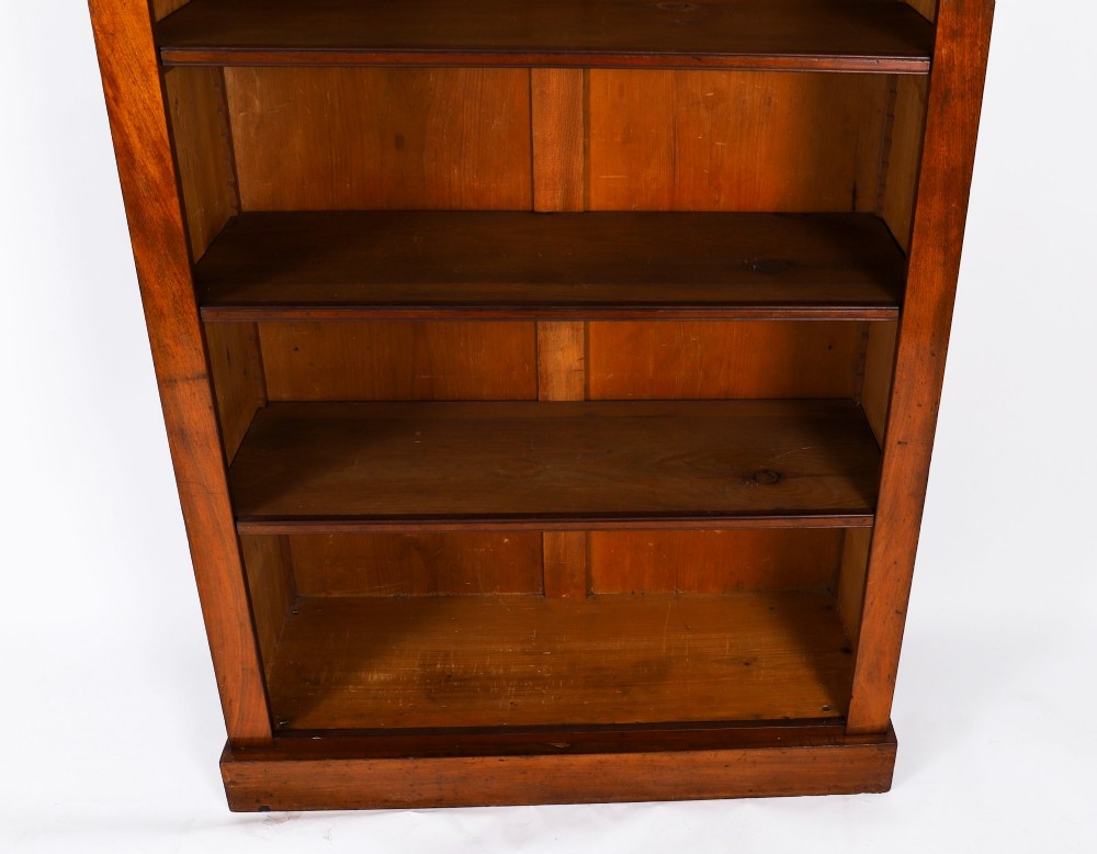A tall Victorian mahogany open bookcase featuring six tiers of adjustable shelves, flanked by decorative carved corbels under a projected cornice. View IV
