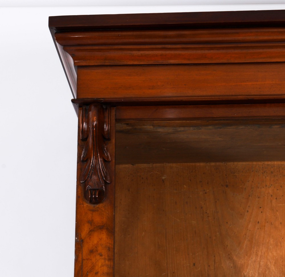 A tall Victorian mahogany open bookcase featuring six tiers of adjustable shelves, flanked by decorative carved corbels under a projected cornice. View VI