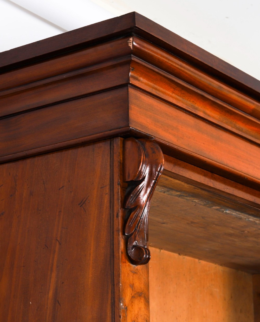 A tall Victorian mahogany open bookcase featuring six tiers of adjustable shelves, flanked by decorative carved corbels under a projected cornice. View VIII