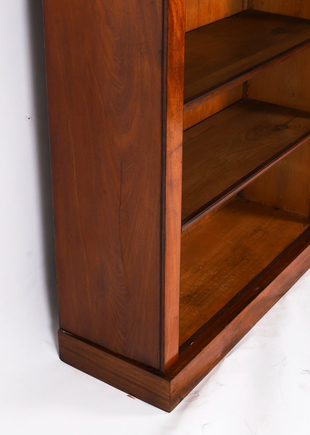 A tall Victorian mahogany open bookcase featuring six tiers of adjustable shelves, flanked by decorative carved corbels under a projected cornice. View IX