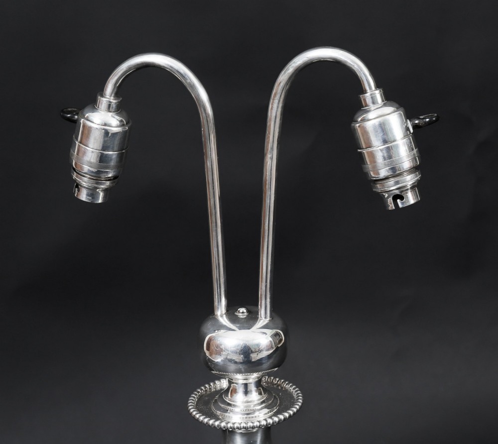 An Art Deco silver-plated twin-arm table lamp with a faceted stem and hexagonal base. View III