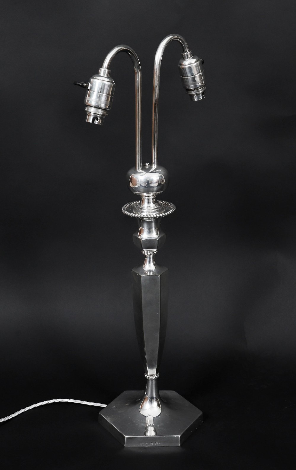 An Art Deco silver-plated twin-arm table lamp with a faceted stem and hexagonal base. View IV