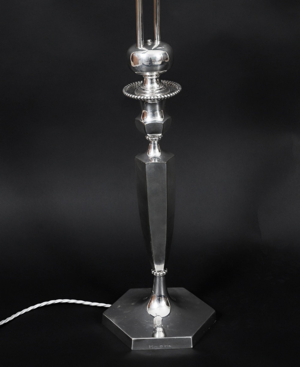 An Art Deco silver-plated twin-arm table lamp with a faceted stem and hexagonal base. View V