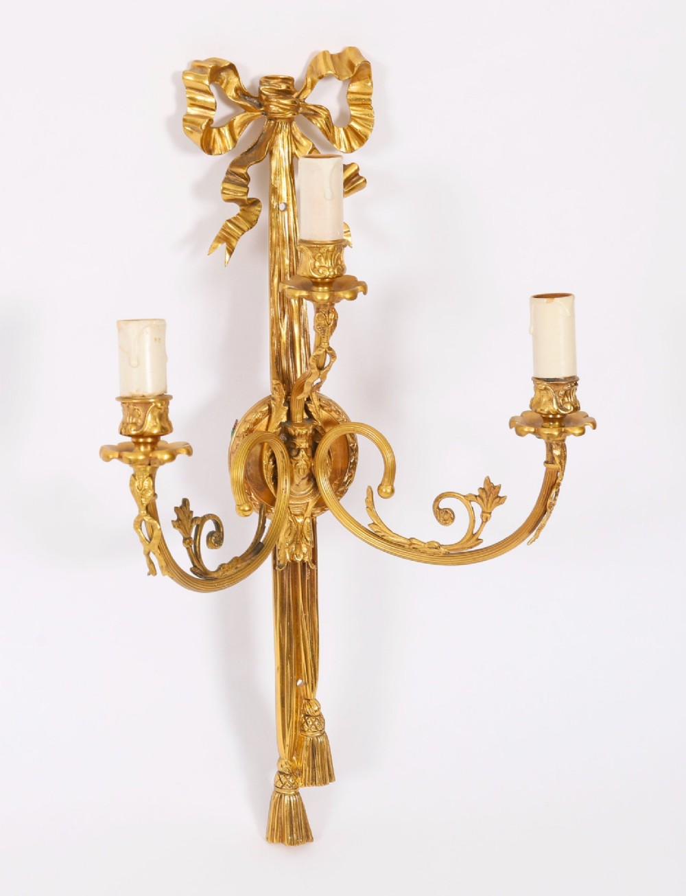 Set of four gilt bronze three-branch wall lights featuring ribbon bow cresting and hanging tassel drops. View IV