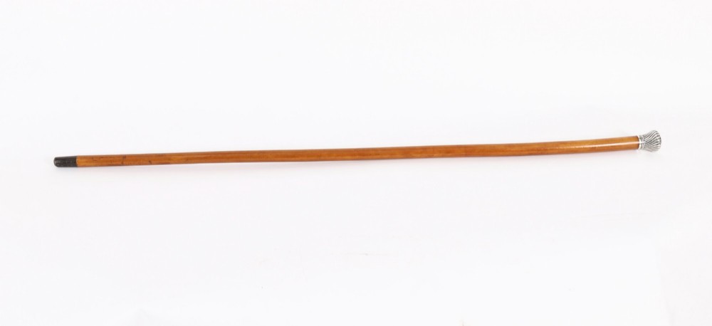 Victorian walking cane featuring an engraved sterling silver pommel with spiralled fluting mounted on a light wood shaft. View II