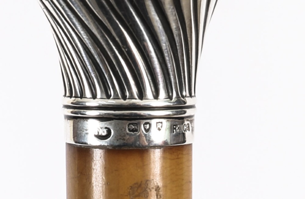 Victorian walking cane featuring an engraved sterling silver pommel with spiralled fluting mounted on a light wood shaft. View XI