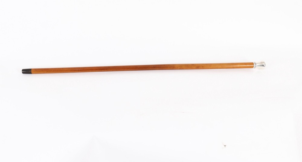 An Edwardian walking stick featuring a smooth domed sterling silver pommel and a polished wooden shaft. View II